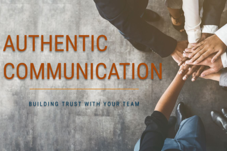 Authentic communication in leadership and teamwork — diverse team members joining hands in trust, symbolizing collaboration, transparency, and building stronger workplace relationships.