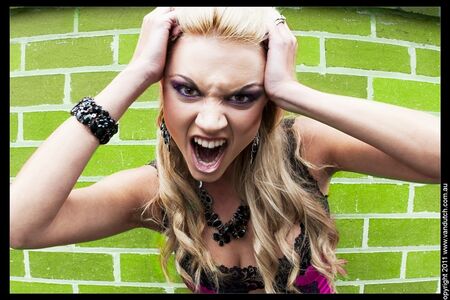 closeup face of a female showing expressions of anger and rage