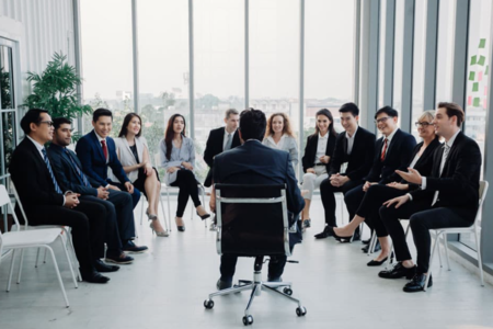 Group leader surrounded by his teammates for a comprehensive leadership workshop