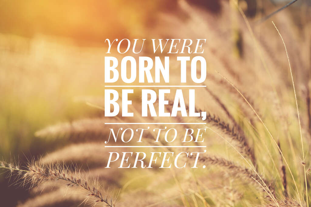 Text on a background of a field reading You Were Born to Be Real, Not to Be Perfect