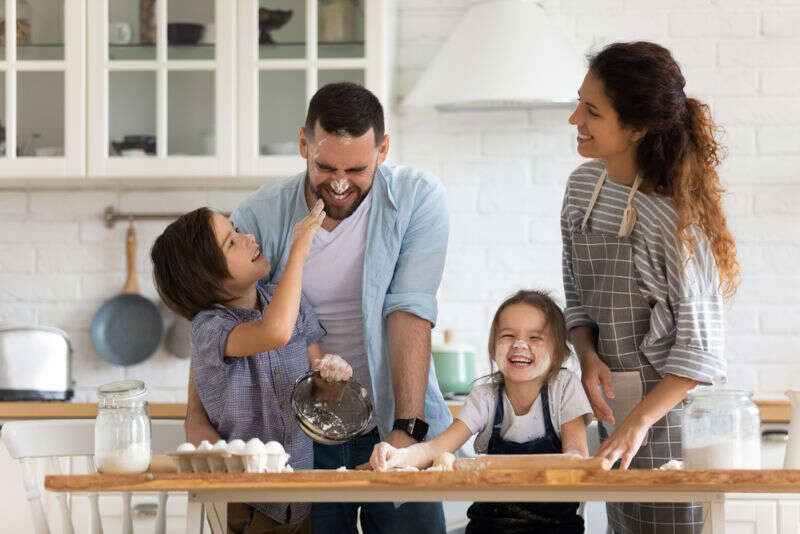 parents and kids baking and laughing