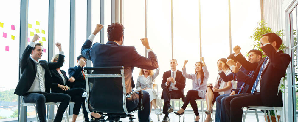 People siting in a circle cheering