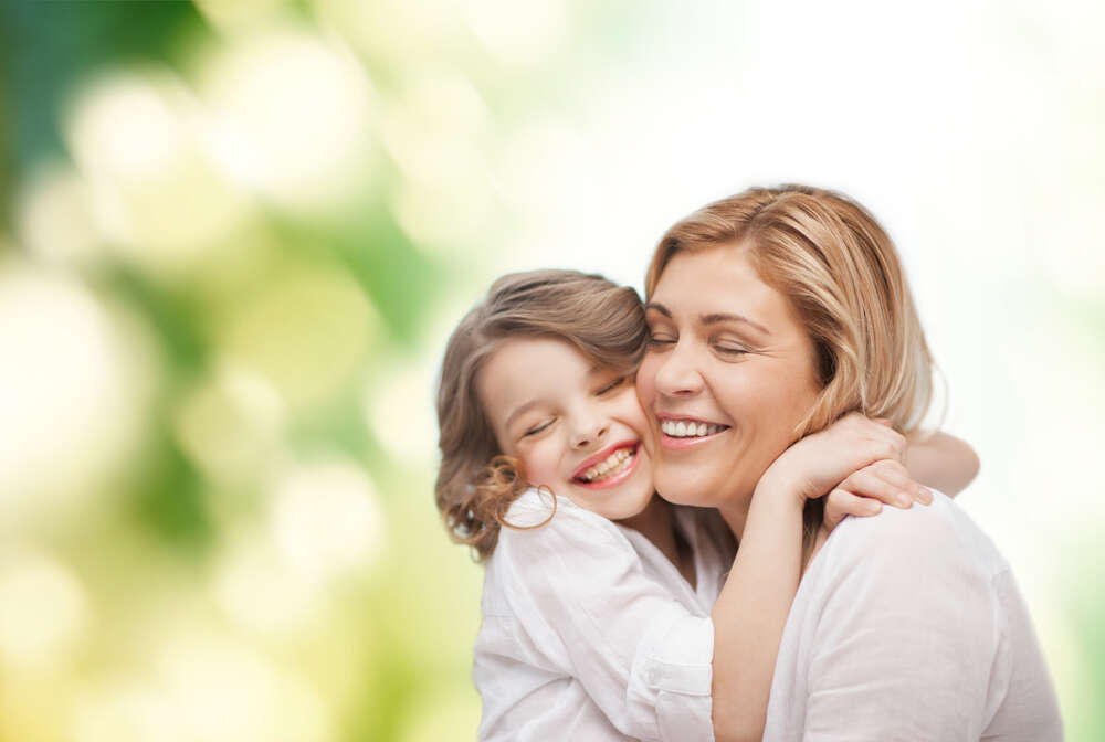 Mother and daughter hugging